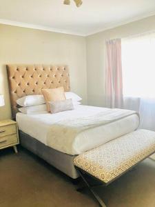 a bedroom with a large bed and a window at ThangoRes in Midrand