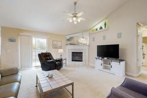 a living room with a tv and a fireplace at East Bay Getaway in Navarre