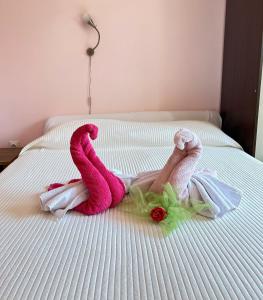 a person laying on a bed with a pink towel at Avlija Garden Gem in Sarajevo