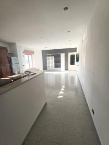 a large kitchen with white walls and a white tile floor at Vista Monte Retreat in Reggio di Calabria