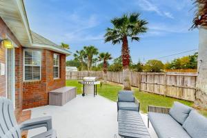 a patio with chairs and a table and a fence at East Bay Getaway in Navarre