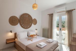 a bedroom with a bed with a table on it at Treasure of Herbs Complex in Panormos Rethymno