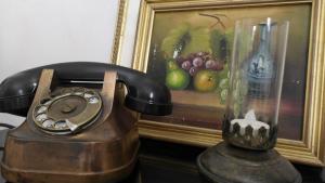 an old telephone sitting next to a picture of fruit at Casa Agello B&B in Ripatransone
