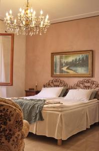a bedroom with a bed and a chandelier at Casa Agello B&B in Ripatransone