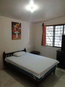 a bedroom with a large bed in a room at Departamentos monumento in Oaxaca City
