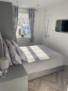 a bedroom with a large bed and a window at Savannah Lodge in Wyke Regis