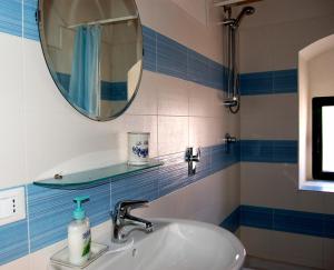 a bathroom with a sink and a mirror at Casa Vacanze Magnolia in Punta Secca