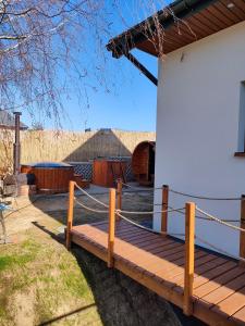 a wooden deck on the side of a house at Oaza U Leszka-dom całoroczny z sauną i ruską banią in Podgórze