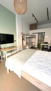 a bedroom with a large bed and a flat screen tv at Origen Valladolid in Valladolid