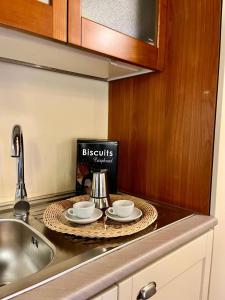 a kitchen counter with two tea cups and a book at Casale Collecchio Siena in Siena +39 photos