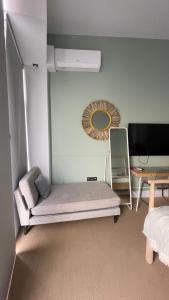 a room with a bed and a tv and a mirror at Origen Valladolid in Valladolid