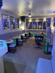 a restaurant with tables and chairs and a pool table at Clifton Private Hotel in Blackpool
