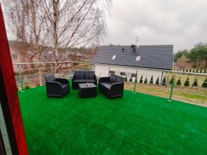 two chairs and a table on a green lawn at Oaza U Leszka-dom całoroczny z sauną i ruską banią in Podgórze