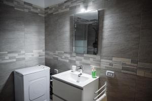 a bathroom with a sink and a mirror at Dimora Antonia in Lecce