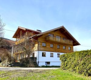 a large wooden house with a wooden roof at Bergbauernhof Wechs in Ofterschwang