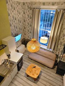 a living room with a couch and a window at Boutique Studio in King's Cross in London