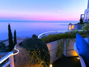 a balcony with a view of the ocean at dusk at Aquaboutique Wellness&Spa in Vietri sul Mare