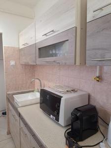 a microwave sitting on a counter in a kitchen at BB Panorama apartman in Budapest