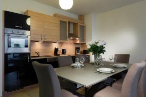 a kitchen and dining room with a table and chairs at Villa Doria in Luxembourg