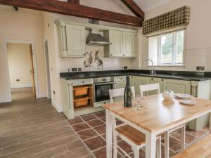 a kitchen with a wooden table and a dining room at Skipper in Lancaster