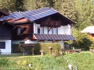 a house with solar panels on the roof at Almhaus Florian in Treffen