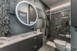 a bathroom with a sink and a mirror at Apartament Agat Lublin Centrum in Lublin
