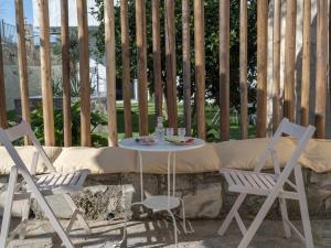 einen Tisch und zwei Stühle auf einer Terrasse in der Unterkunft Treasure of Herbs Complex in Panormos