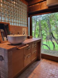 a bathroom with a sink and a large window at Lo Chalet d'Argento in Porto Ercole