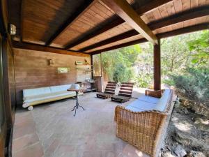 a patio with chairs and a table and a kitchen at Lo Chalet d'Argento in Porto Ercole