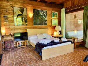 a bedroom with a bed and a television in it at Lo Chalet d'Argento in Porto Ercole