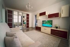 a living room with a couch and a flat screen tv at Luxury Apartament Ultracentral of Suceava Esplanada in Suceava