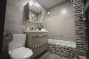 a bathroom with a toilet and a sink and a tub at Luxury Apartament Ultracentral of Suceava Esplanada in Suceava +25 photos