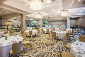 a banquet hall with white tables and chairs at Memphis Vitality Hotel in Memphis