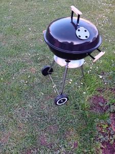 a bbq grill sitting on the grass at Indian tent glamping in Mrše