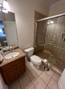a bathroom with a toilet and a shower and a sink at 5 Plus Bedroom Over Sized Colonial in Very Private Setting in Pound Ridge