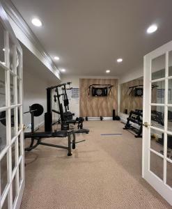 a gym with several tread machines in a room at 5 Plus Bedroom Over Sized Colonial in Very Private Setting in Pound Ridge