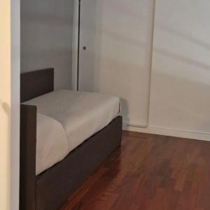un piccolo letto in una camera con pavimento in legno di Maison Michela Sorrento a Sorrento