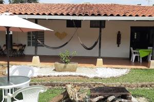 Casa con patio y mesa con sombrilla en Casa campestre con las comodidades de la ciudad, en Jamundí