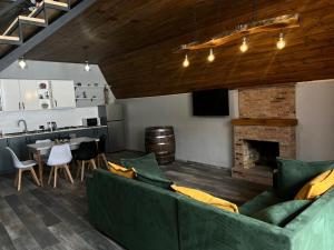 a living room with a couch and a fireplace at Deka Achkhoti in Kazbegi