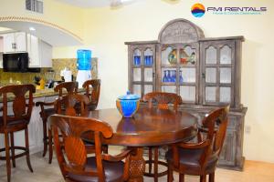 a dining room with a wooden table and chairs at Marina Pinacate Villa-13 in Puerto Peñasco