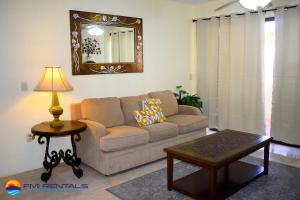 a living room with a couch and a table and a mirror at Marina Pinacate Villa-13 in Puerto Peñasco