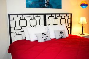 a bedroom with a red bed with white pillows at Marina Pinacate Villa-13 in Puerto Peñasco