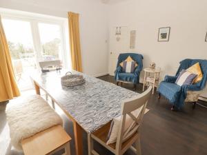 a dining room with a table and two chairs at Harbour Village Views in Goodwick