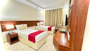 Säng eller sängar i ett rum på Rafahya Hotel Makkah فندق رفاهية مكة