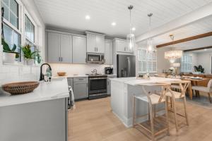 an open kitchen and dining room with white cabinets at Shore To Escape at Hunter's Point in Cortez