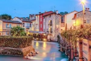 een rivier in een stad met huizen en gebouwen bij Casa Borghetto 8 Lago di Garda in Valeggio sul Mincio
