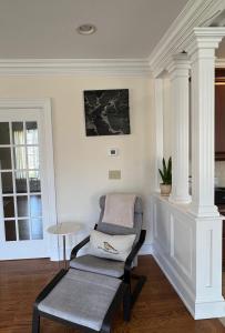 a living room with a chair and a table at 5 Plus Bedroom Over Sized Colonial in Very Private Setting in Pound Ridge