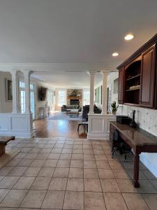 a large living room with a tile floor at 5 Plus Bedroom Over Sized Colonial in Very Private Setting in Pound Ridge +11 photos