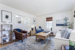 a living room with a couch and a table at Charming Beachside Home in Bridgeport