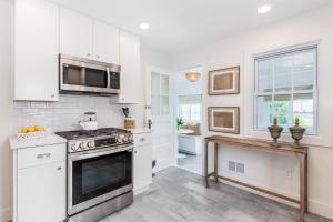 a kitchen with a stove and a microwave at Charming Beachside Home in Bridgeport